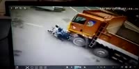 Motorcyclists fall under the truck