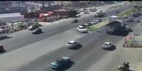 Careless woman crossing the busy road gets struck by car
