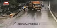 Umbrella man surprised by domp truck
