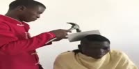 Cutting hair with a hammer and old broken Machete blade
