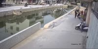 Guy drives his scooter into the sewer