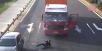 Truck driver gets hit by a car when checking out his truck