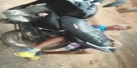 Rider holds leg on rear tire. (R)