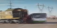 Train destroys the bus injuring a driver