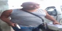 Angry bald man with pistol beats a criminal