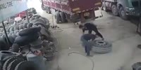 Tire explodes when the worker lifts it up