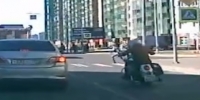 Harley rider knocks a girl on crosswalk
