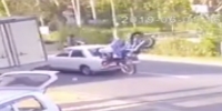 Dang! Biker rear ends a car breaking window with his head