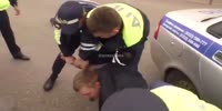 Man knocks officer's cap of his head...(Better quality)