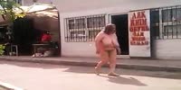 Naked fat woman walks in street