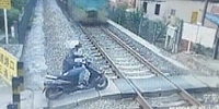 Scooter Man Can't Beat the Train