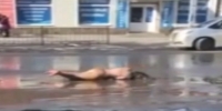 Nude Russian girl takes a mud bath