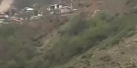 big stone rolling over houses