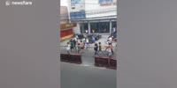 Filipino motorcyclists are punished to walk along streets with helmets after being caught riding without protective gears