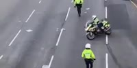 Cop on motorcycle tries to hit protesters in Hong Kong
