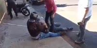 Man in arm lock gets kicked.