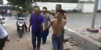 Thief beaten with helmets