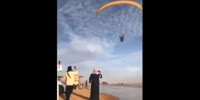 Skydiver lands on Arabs (R)