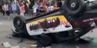 Crazy Protestor SHITS on Police Car