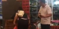 Shop owner beats woman