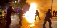 RIOTERS TRY TO LIGHT COPS ON FIRE