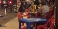 Woman Smacks Her Husbannd Chilling In The Street Bar