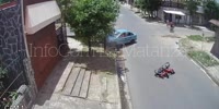 blue car crashes into red bike