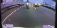 Biker Sandwiched Between Cars