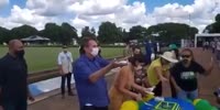 Brazil's president Bolsonaro wash his hands in the dirt water before serve cake to his cattle