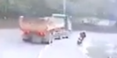 Biker’s Legs Ran Over by Truck