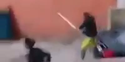 Woman Beating With A Stick In Violent Argument