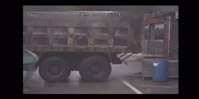 Biker Slide-Tackled by Truck