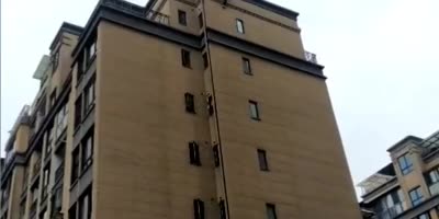 Crowd Watches As  Man Falls To His Death From A Tall Building In China