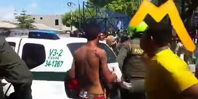 Arrested Thief Getting Punched In Freont Of Police In Colombia