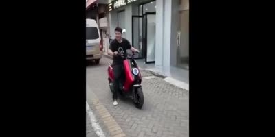 Dude on Red Moped Drives for the First Time
