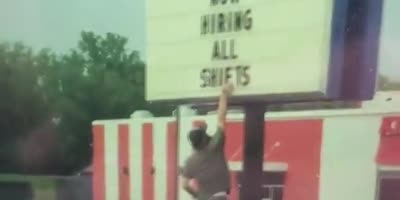 Man corrects Burger King sign.