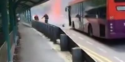 Fire-fighters next to vehicle as it explodes.