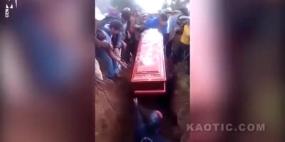 Woman's body falls out of her coffin.