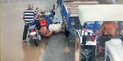 Man Falls Head First Under Tractor Wheels