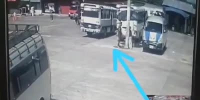 Street Vendor Sandwiched Between Bus and Pole