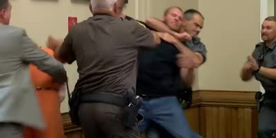 Baby killer gets slammed in the face while leaving courtroom.