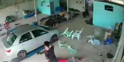 Runaway Tire Hits A Man In A Shop(R)