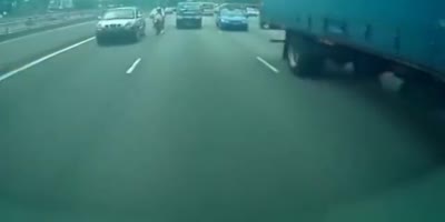 Biker knocked into truck, gets mooshed.