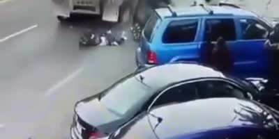 Man sandwiched between backing car and truck.