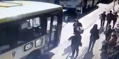 Woman Stuck In Her Phone Knocked Out By The Bus