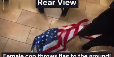 Angry Cop Wipes Her Feet On US Flag!