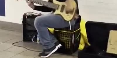 One Handed Playing The Guitar At Union Square.