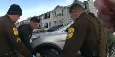 Police Officers And A Good Samaritan Lift SUV Off Trapped 70 Year Old Woman.