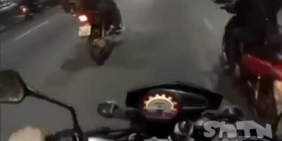 Man on motorcycle showing off, slams into car.