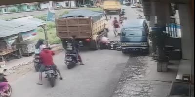 Woman Faints After Husband Falls Under Truck Wheel In Indonesia